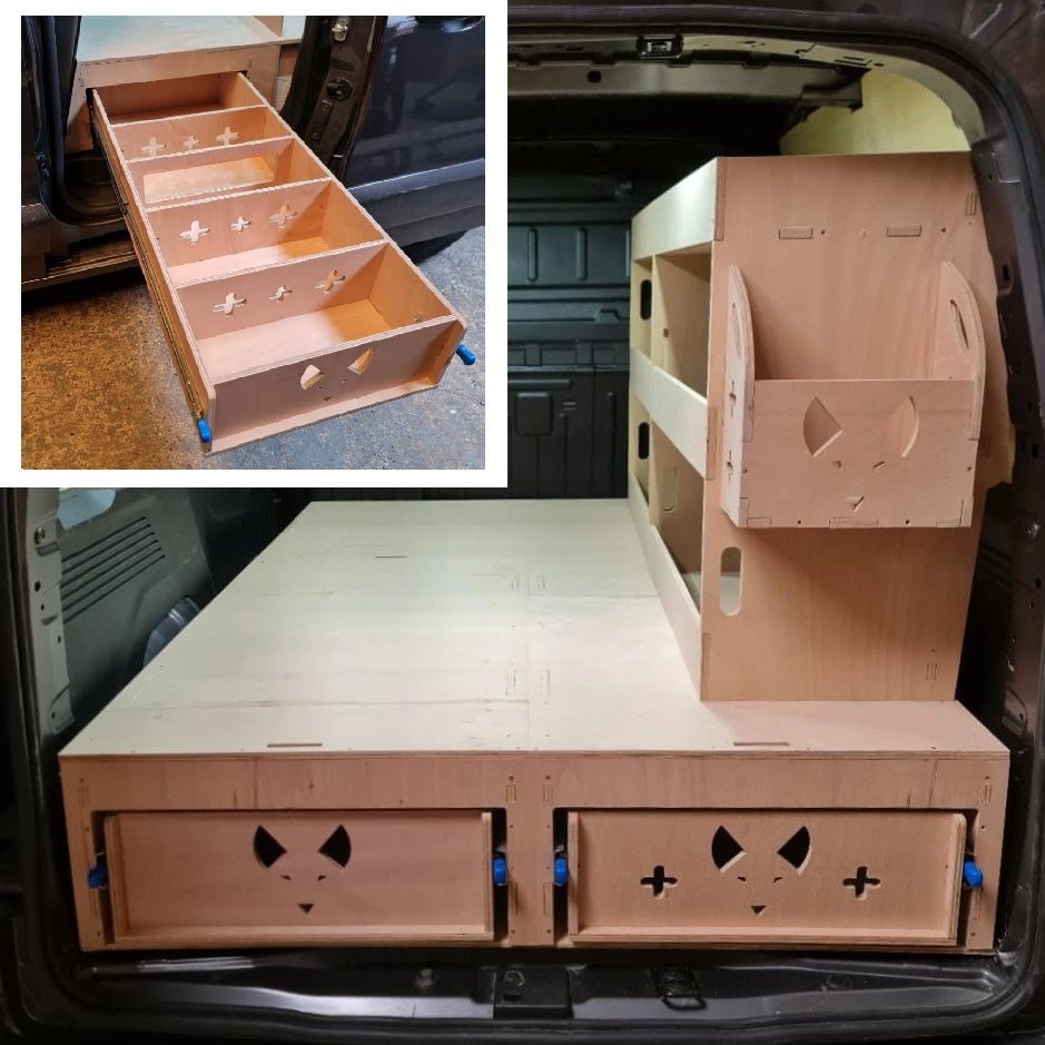 Wooden storage unit with drawers and shelves in a vehicle trunk
