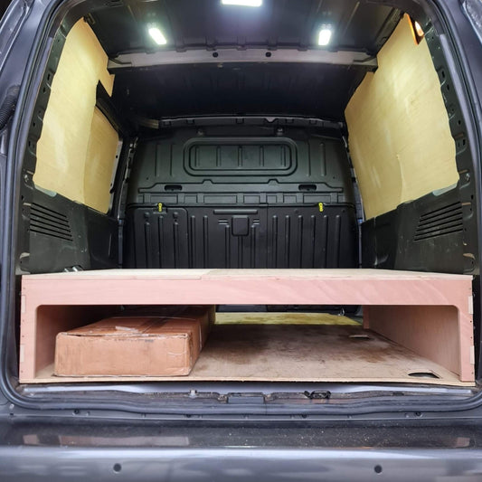 Trunk of a vehicle with a wooden platform