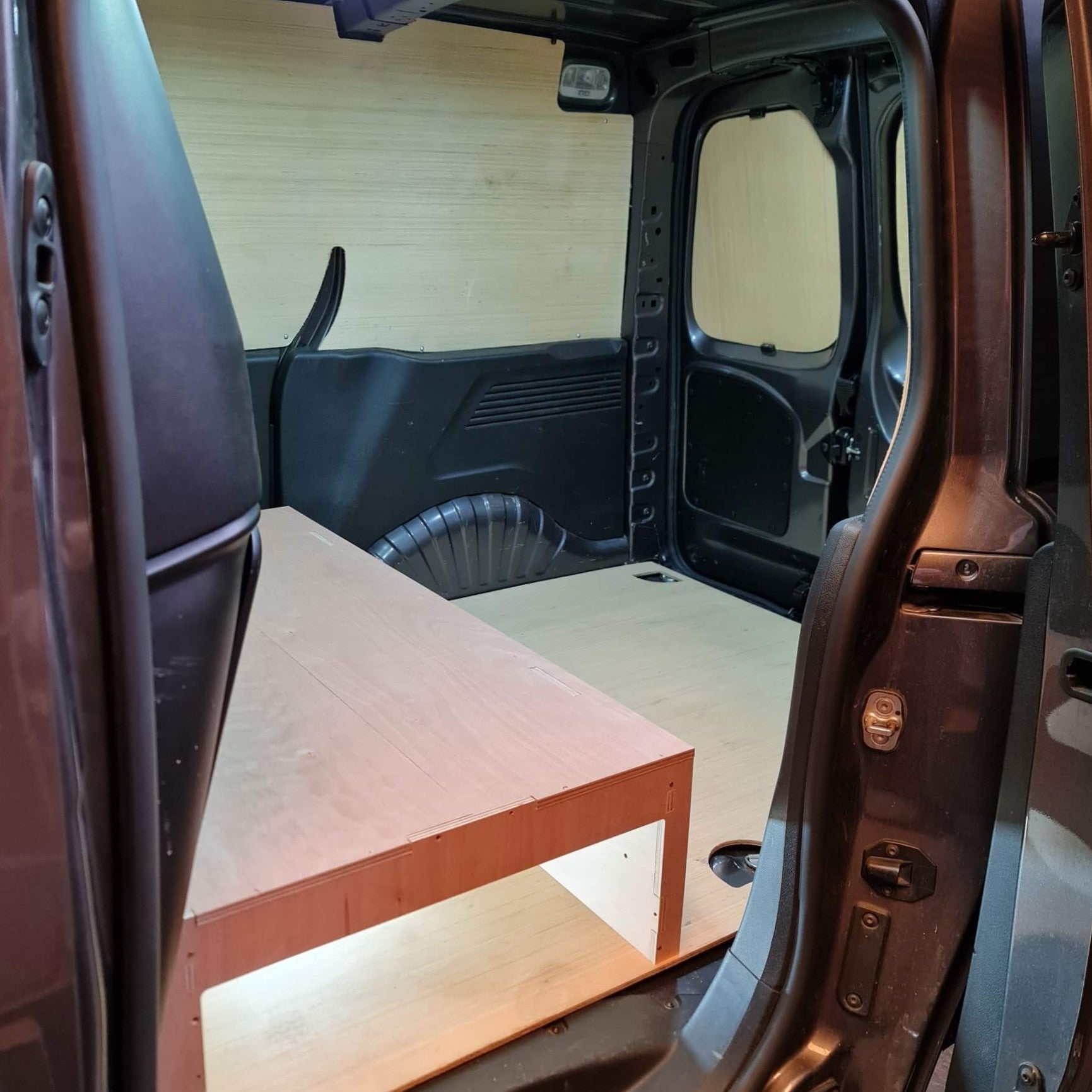 Wooden platform inside a vehicle with a wooden wall background