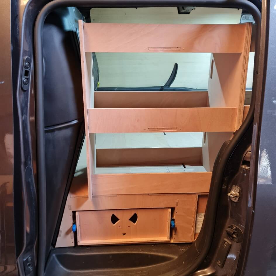 Wooden storage unit with drawers inside a vehicle