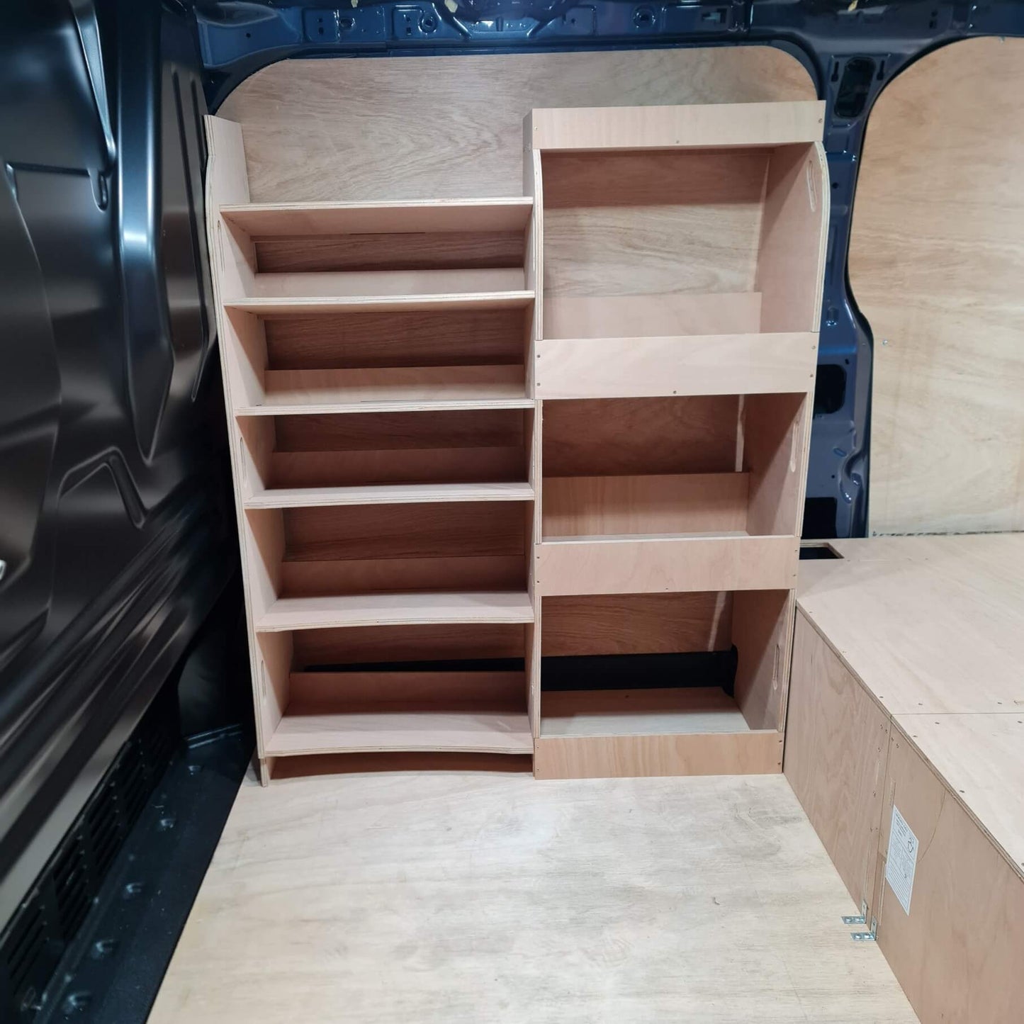 Wooden shelves inside a vehicle, likely for storage.
