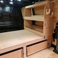 Wooden bed and storage system inside a van
