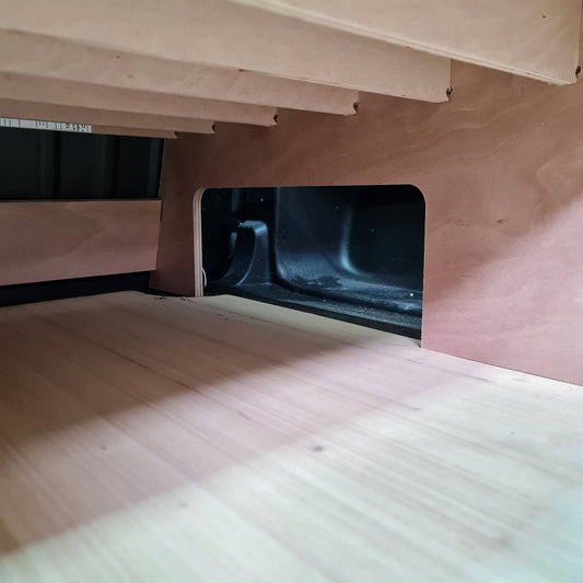 Wooden Van furniture with a gap showing a dark interior