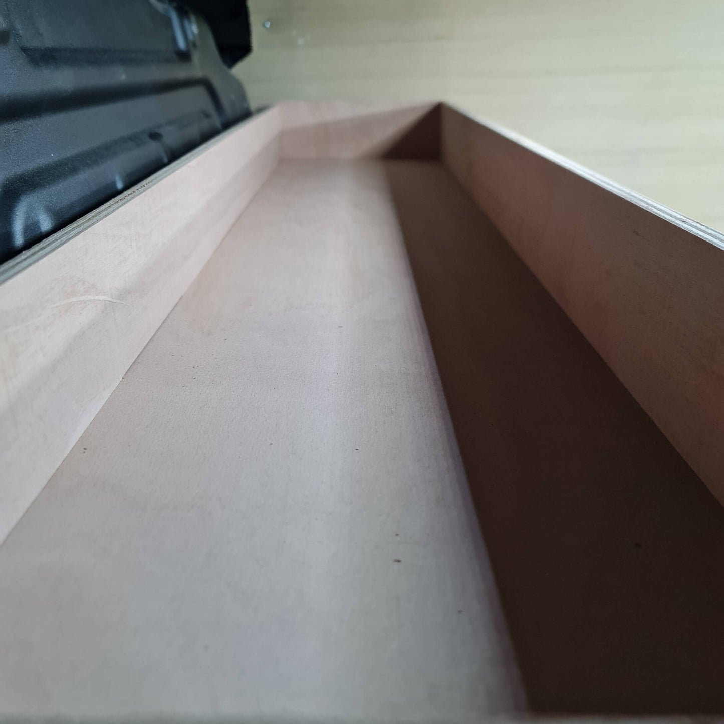 Close-up of a cardboard box corner on a wooden surface