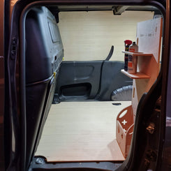 Van interior with a shelf and supplies inside