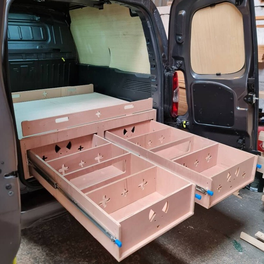 Wooden storage drawers inside an open van