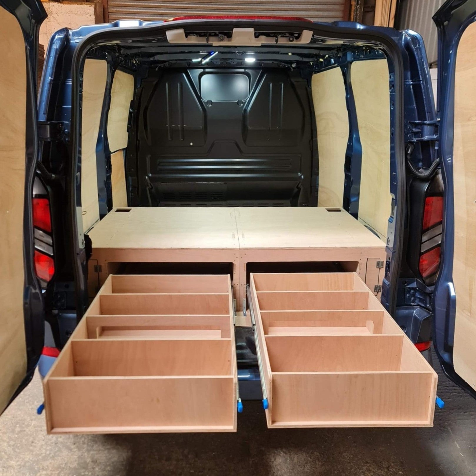 Wooden storage drawers installed in the back of a van