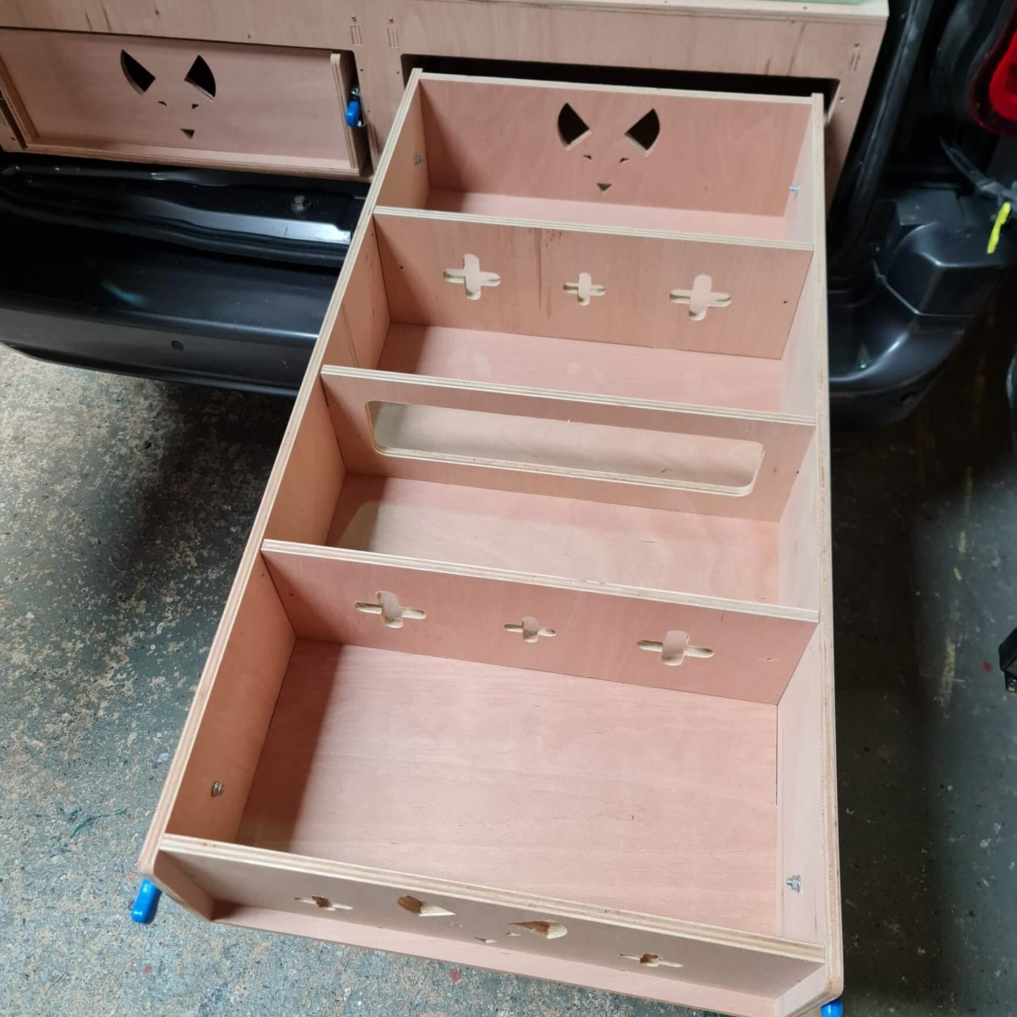 Wooden drawer with fox designs on a concrete floor