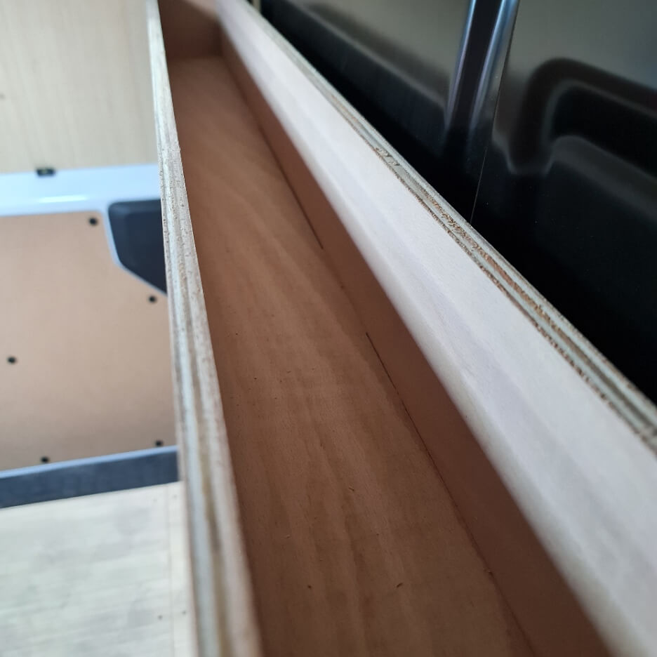 Top rail shelf for plunge saw guide rails and spirit levels – part of bulkhead-side van racking for SWB/LWB vans