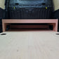Wooden platform with a black toolbox in the background