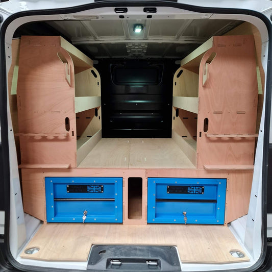 Van interior with wooden walls and blue storage drawers.
