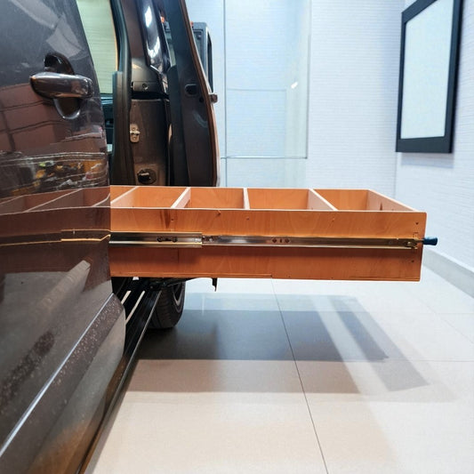 Wooden cargo tray attached to a vehicle in a garage setting