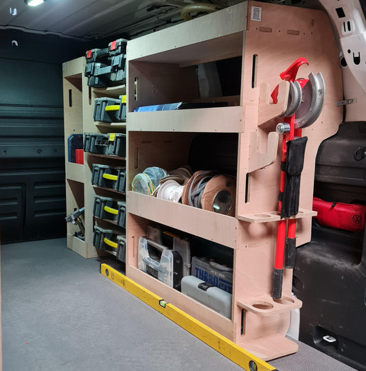 Tool storage system inside a vehicle with various tools and equipment.