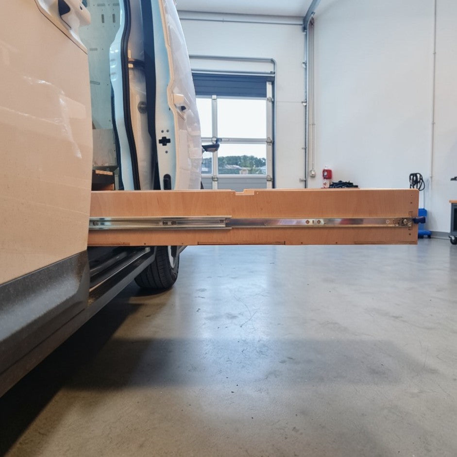 Kia PV5 Van with a Drawer extension in a garage