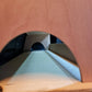 Wooden racking with a circular cutout revealing a dark interior