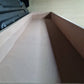 Close-up of a cardboard box corner on a wooden surface