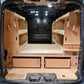 Van interior with wooden shelves and a bed setup