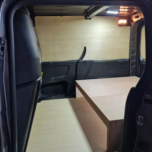 Van interior with a wooden floor and bench seat