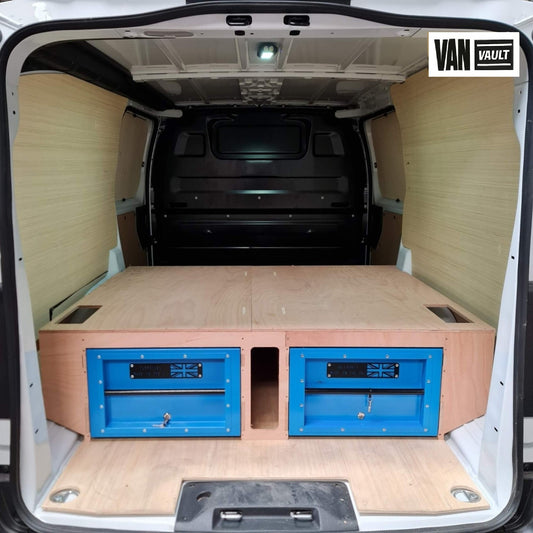 Van interior with wooden floor and blue storage drawers, branded 'Van Vault'.