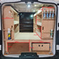 Measurement details of a van interior setup with wooden shelves and storage compartments.