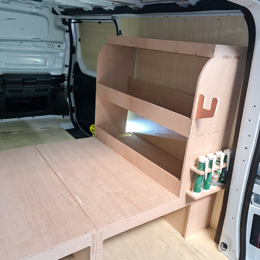 Wooden storage unit with tools inside, attached to a vehicle's open cargo area.