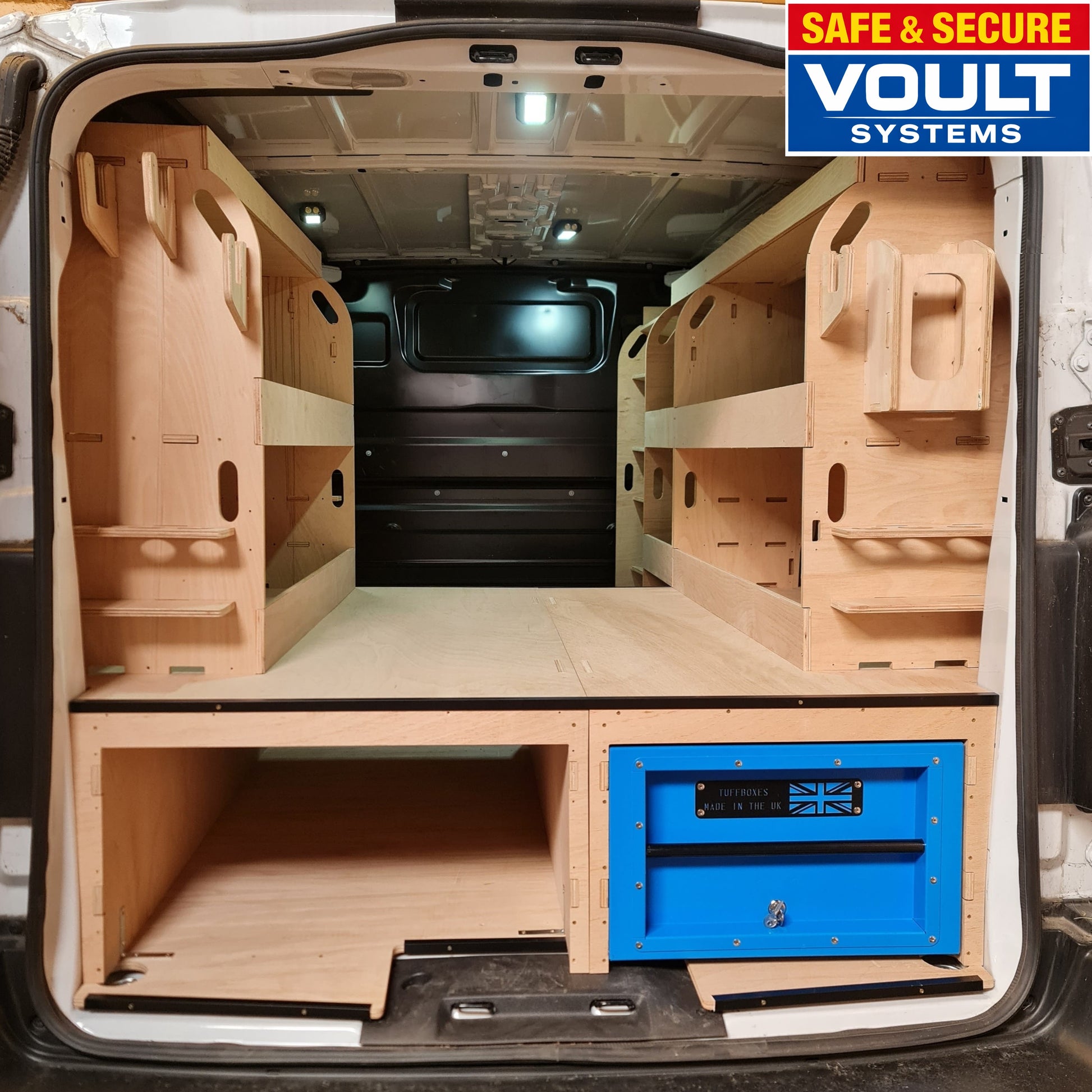 Wooden storage compartments in a vehicle with 'VOULT Systems' branding.
