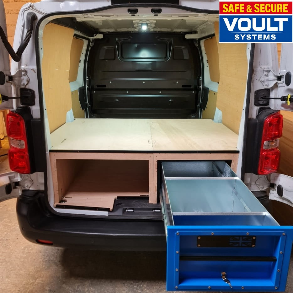 Van interior with storage compartments and Voult Systems logo.