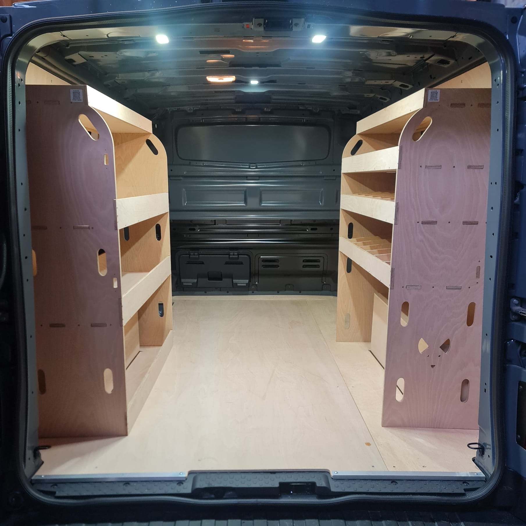 Van interior with wooden shelves and storage compartments