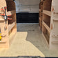 Van interior with wooden shelves and tools arranged inside