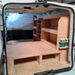 Van interior with wooden shelves and storage compartments